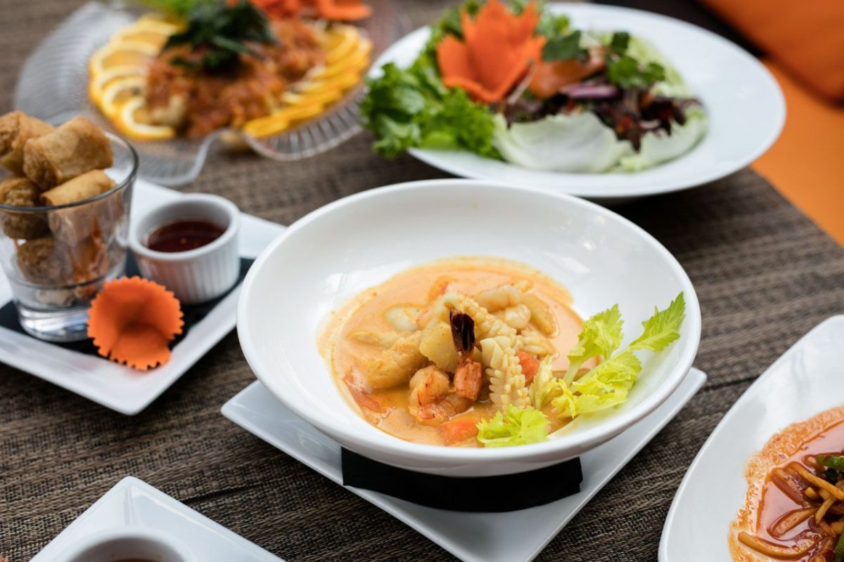 Creamy seafood curry in white bowl.