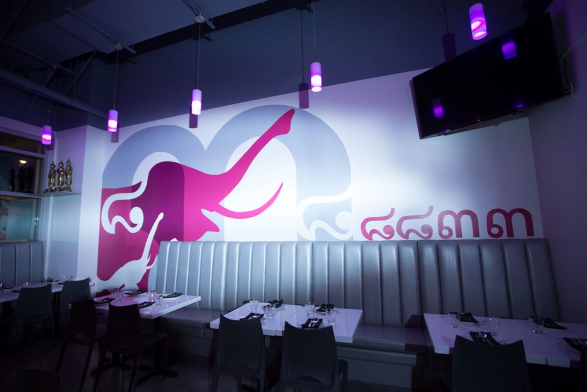Thai restaurant interior with elephant mural.
