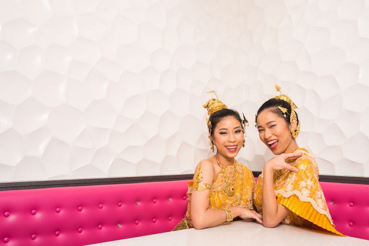Two women in traditional Thai clothing.