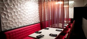 Restaurant booth with textured wall.