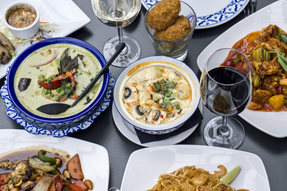Delicious Thai food and wine spread.